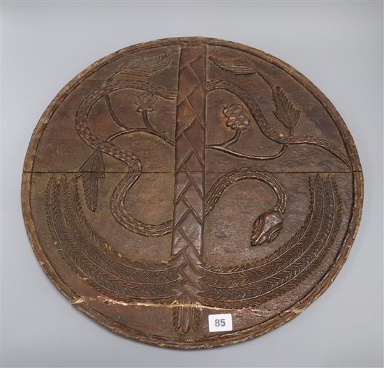 A carved African shield 51cm diameter